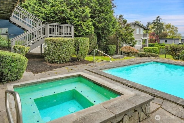 outdoor pool with fence and stairway