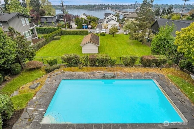outdoor pool featuring a lawn, a residential view, and a fenced backyard