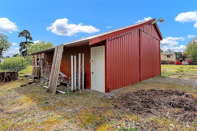 view of outbuilding with fence and an outdoor structure