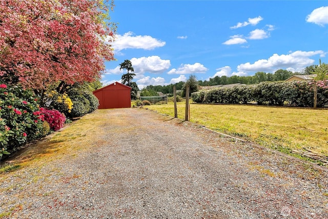 view of road featuring an outbuilding and driveway