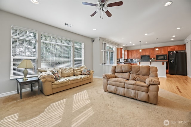 living area with recessed lighting, baseboards, visible vents, and a ceiling fan