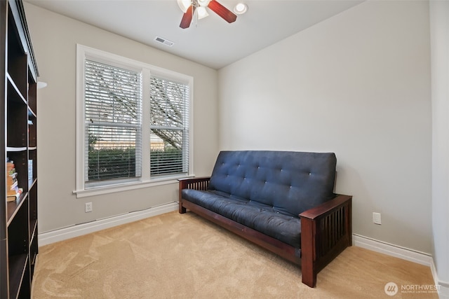 living area featuring visible vents, carpet flooring, baseboards, and ceiling fan
