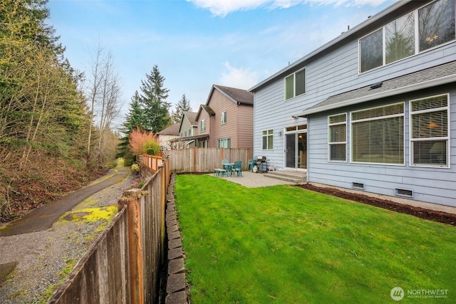 back of house with a lawn, a fenced backyard, a patio area, and entry steps
