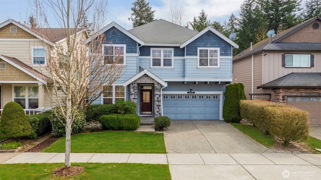 craftsman house with an attached garage, a front yard, stone siding, and concrete driveway