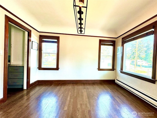 empty room featuring a baseboard radiator, dark wood-style flooring, healthy amount of natural light, baseboards, and ornamental molding