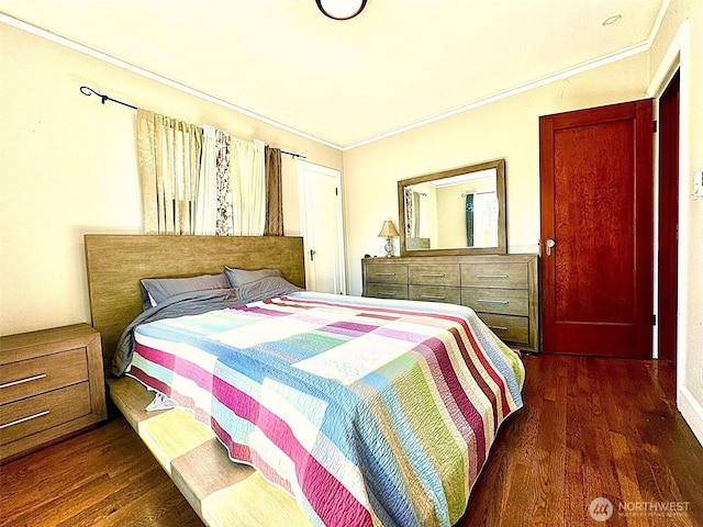 bedroom with dark wood-style floors and ornamental molding