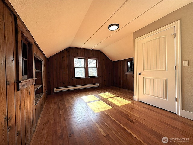 bonus room featuring a baseboard radiator, wood-type flooring, and lofted ceiling