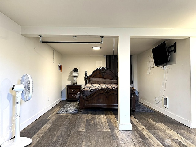 bedroom with wood finished floors and baseboards