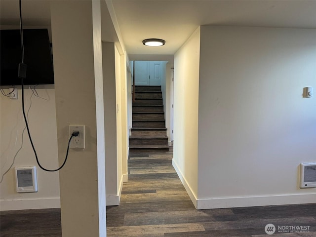 hallway with dark wood finished floors, baseboards, and stairway
