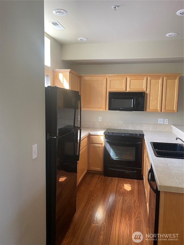11406 SE 171st St Unit 14, Renton, WA 98058 - kitchen featuring dark wood-type flooring, light brown cabinets, black appliances, and a sink