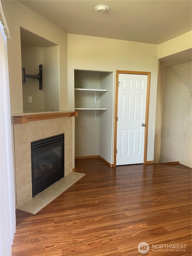 11406 SE 171st St Unit 14, Renton, WA 98058 - unfurnished living room with a tile fireplace, baseboards, and wood finished floors