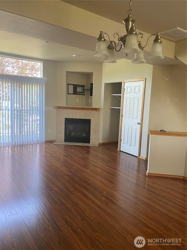 11406 SE 171st St Unit 14, Renton, WA 98058 - unfurnished living room featuring baseboards, a notable chandelier, a fireplace, and wood finished floors