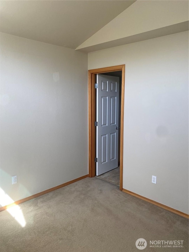 11406 SE 171st St Unit 14, Renton, WA 98058 - empty room featuring light colored carpet, lofted ceiling, and baseboards