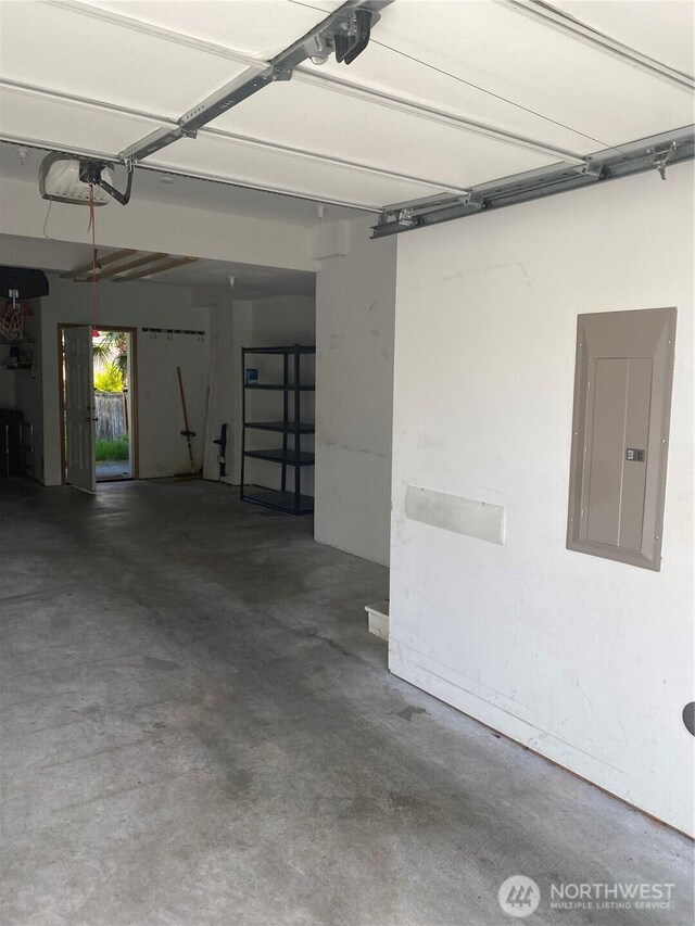 11406 SE 171st St Unit 14, Renton, WA 98058 - garage featuring electric panel and a garage door opener