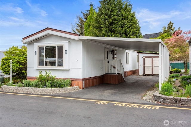 3832 164th St SW Unit 10, Lynnwood, WA 98087 - manufactured / mobile home with aphalt driveway and a carport