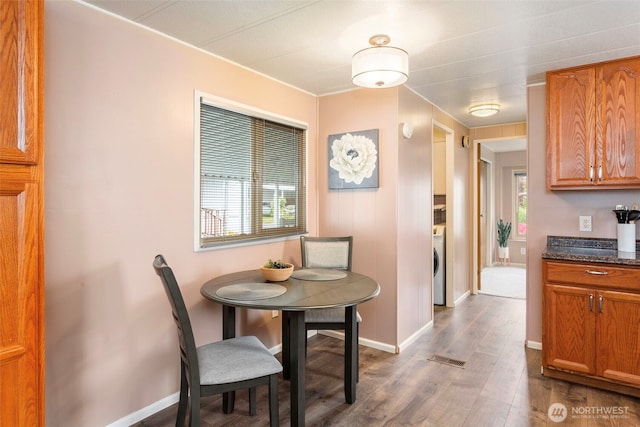 3832 164th St SW Unit 10, Lynnwood, WA 98087 - dining room with baseboards, washer / dryer, wood finished floors, and visible vents