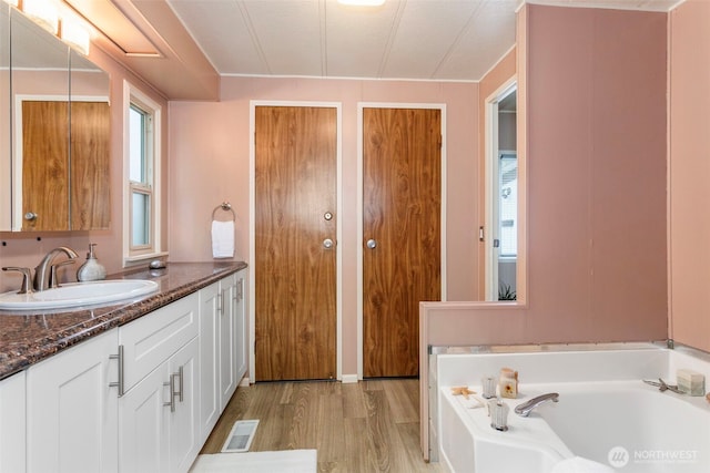 3832 164th St SW Unit 10, Lynnwood, WA 98087 - full bathroom with vanity, a garden tub, wood finished floors, and visible vents