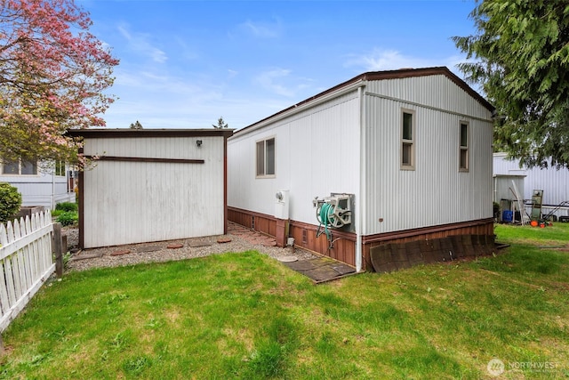 3832 164th St SW Unit 10, Lynnwood, WA 98087 - back of house with a lawn, fence, and an outbuilding