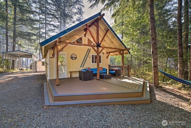 124 Aspen Ln, Packwood, WA 98361 - exterior space with a detached carport, gravel driveway, a deck, an outdoor hangout area, and an outbuilding