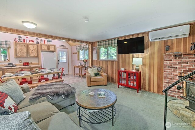 124 Aspen Ln, Packwood, WA 98361 - living room with a wall mounted air conditioner, light carpet, and wood walls