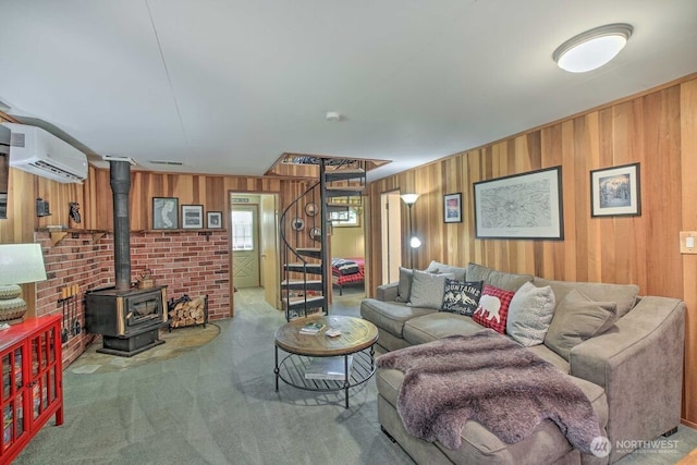 124 Aspen Ln, Packwood, WA 98361 - living area featuring an AC wall unit, a wood stove, carpet floors, and wooden walls