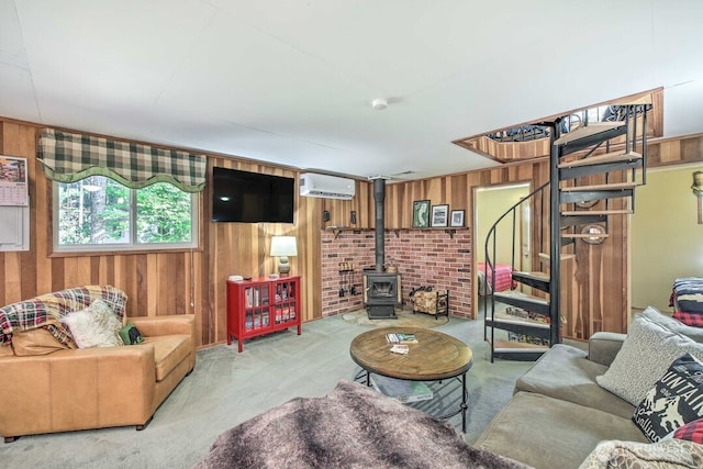 124 Aspen Ln, Packwood, WA 98361 - living room featuring carpet flooring, a wall mounted air conditioner, wood walls, and stairway