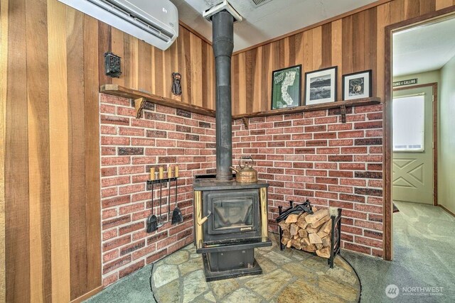 124 Aspen Ln, Packwood, WA 98361 - interior details with carpet floors, a wood stove, and wood walls