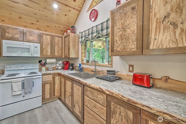 124 Aspen Ln, Packwood, WA 98361 - kitchen with white appliances, light countertops, a sink, light wood finished floors, and vaulted ceiling