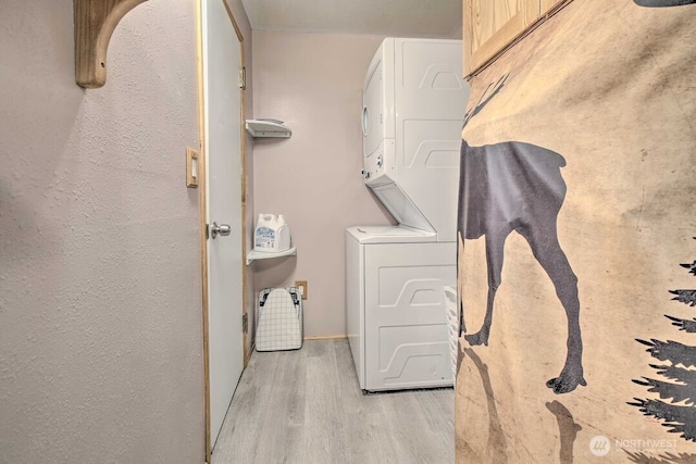 124 Aspen Ln, Packwood, WA 98361 - washroom with stacked washer and clothes dryer, light wood finished floors, and laundry area