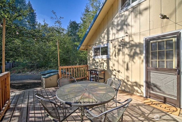 124 Aspen Ln, Packwood, WA 98361 - wooden deck with outdoor dining space and a grill