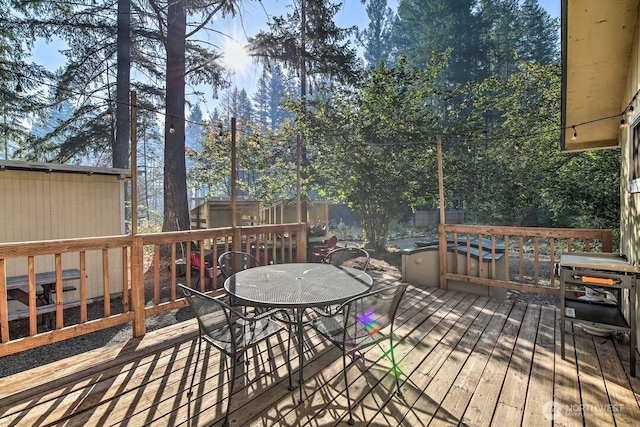 124 Aspen Ln, Packwood, WA 98361 - wooden terrace with a storage shed, fence private yard, an outdoor structure, and outdoor dining space