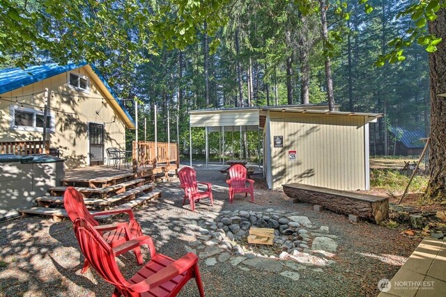 124 Aspen Ln, Packwood, WA 98361 - view of patio with an outbuilding, a wooden deck, and an outdoor fire pit