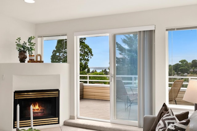 entryway with recessed lighting and a lit fireplace