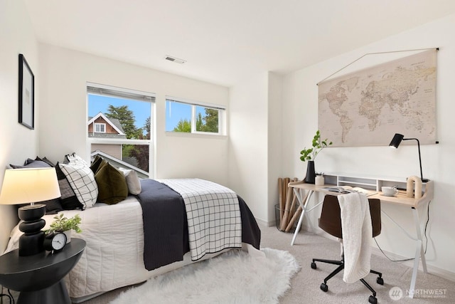 bedroom with carpet and baseboards