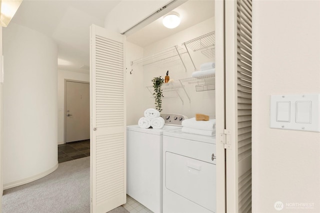 laundry room with washer and clothes dryer and light carpet