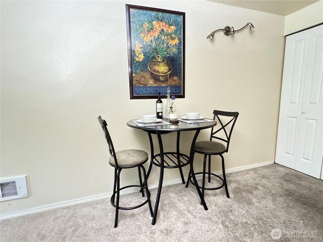 dining room with visible vents, carpet, and baseboards
