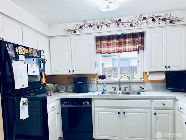 kitchen featuring white cabinetry, black appliances, light countertops, and a sink