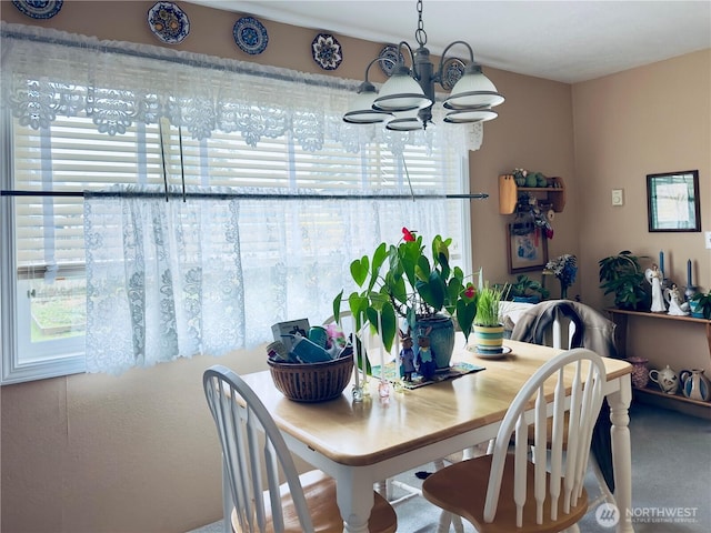 dining space featuring an inviting chandelier