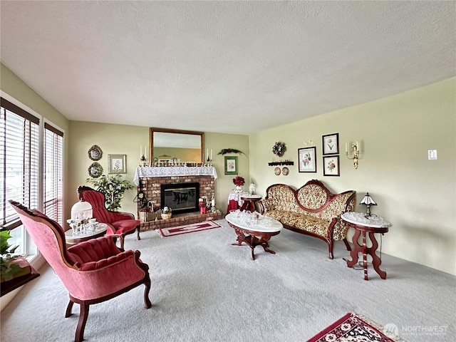 carpeted living area featuring a textured ceiling and a fireplace