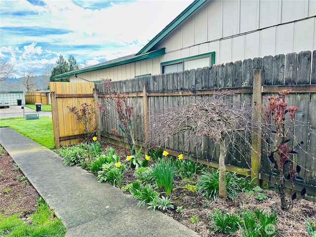 view of side of home featuring fence