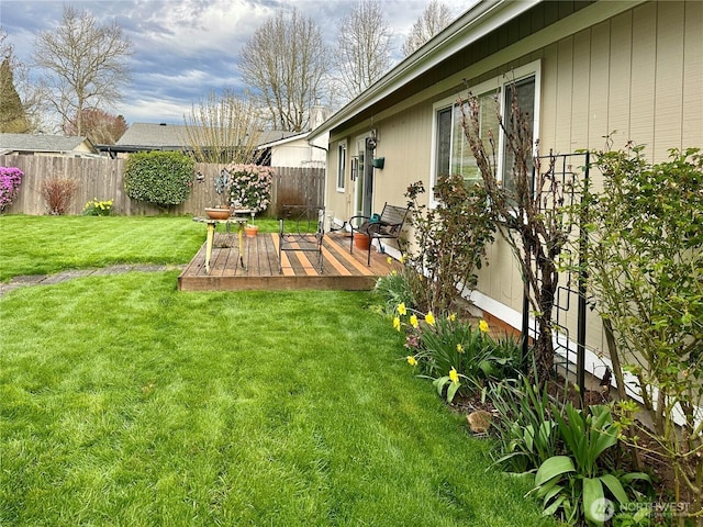 view of yard featuring fence and a deck