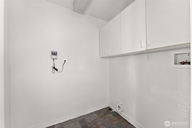 laundry room with cabinet space, baseboards, stone finish floor, and hookup for a washing machine