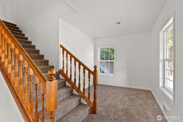 staircase with baseboards, carpet flooring, and visible vents
