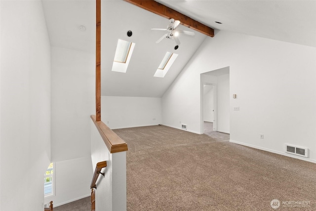 additional living space featuring ceiling fan, carpet flooring, lofted ceiling with skylight, and visible vents