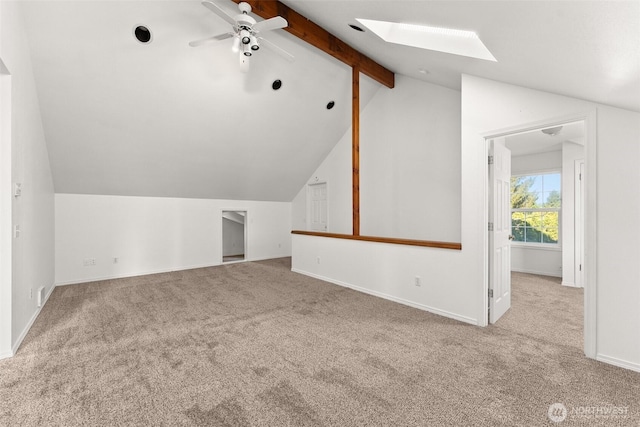 additional living space with baseboards, a ceiling fan, carpet, and lofted ceiling with skylight