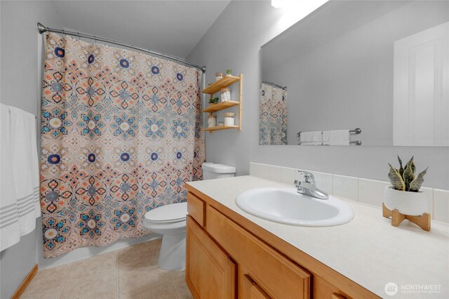 bathroom featuring vanity, tile patterned flooring, and toilet