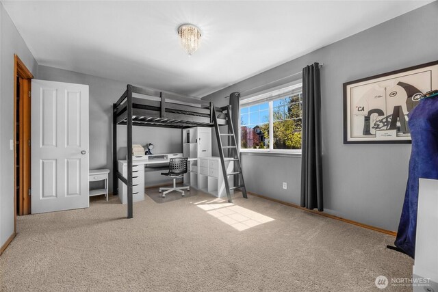 carpeted bedroom featuring baseboards