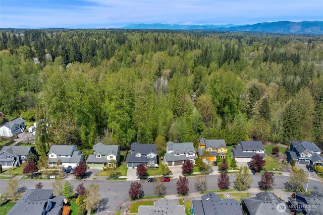 bird's eye view with a residential view, a mountain view, and a forest view