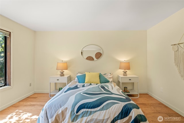 bedroom featuring baseboards and wood finished floors