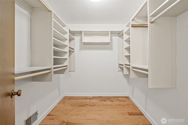 spacious closet with visible vents and wood finished floors